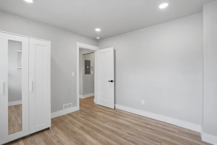 Unit #40 Unfurnished bedroom with light wood finished floors, recessed lighting, a closet, and electric panel