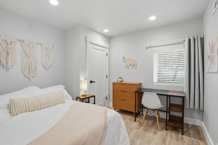 Furnished Unit #44 faces West.  Bedroom featuring recessed lighting and light wood-style floors