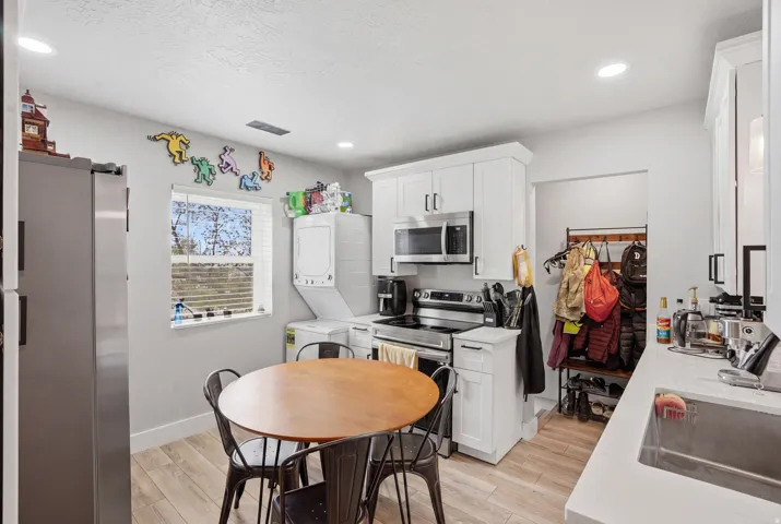 Unit #42 Kitchen featuring stainless steel appliances, light wood-type flooring, white cabinetry, and recessed lighting