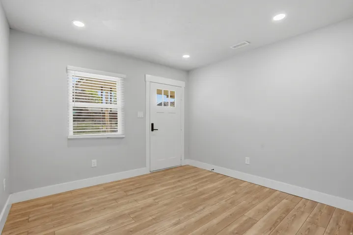 Unit #40 Foyer with light wood-style flooring and recessed lighting