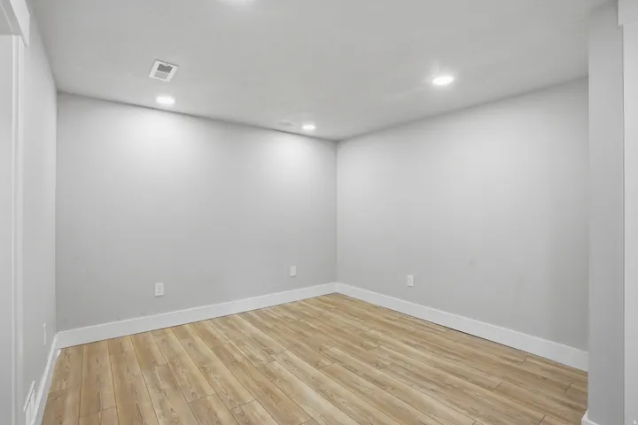 Unit #40 studio apartment with separate entrance.Empty room featuring light wood-type flooring and recessed lighting