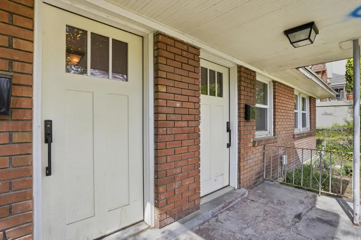 Doorways to right Unit #40 , left unit 42 featuring brick siding and covered porch