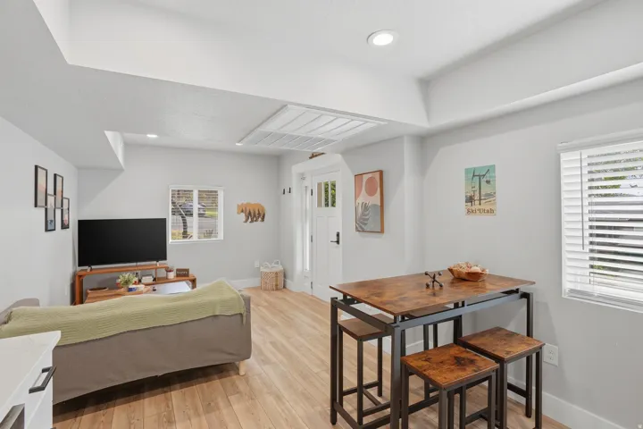 Furnished Unit #44 faces West. Living area featuring light wood-style flooring and recessed lighting