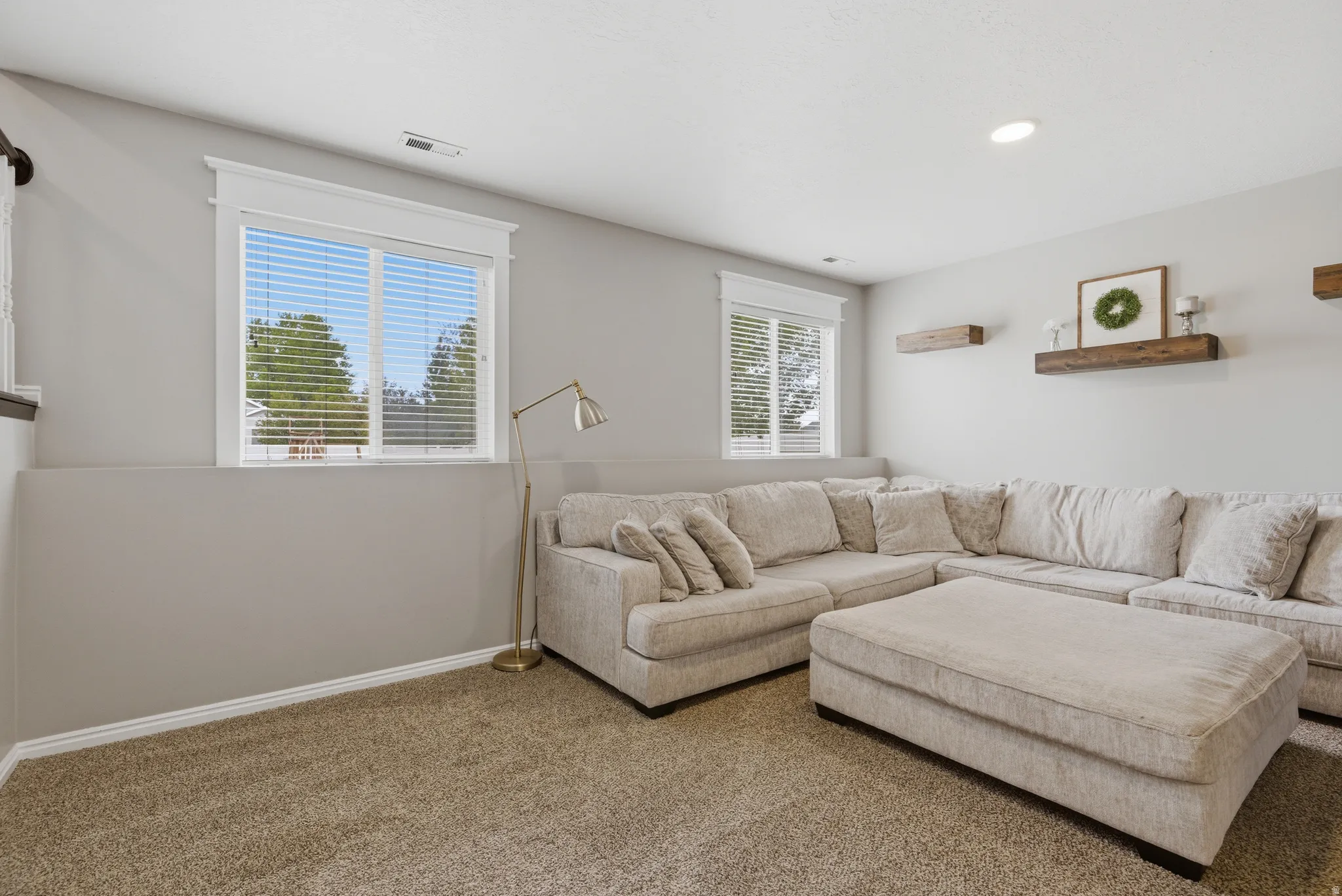 Carpeted living area featuring baseboards
