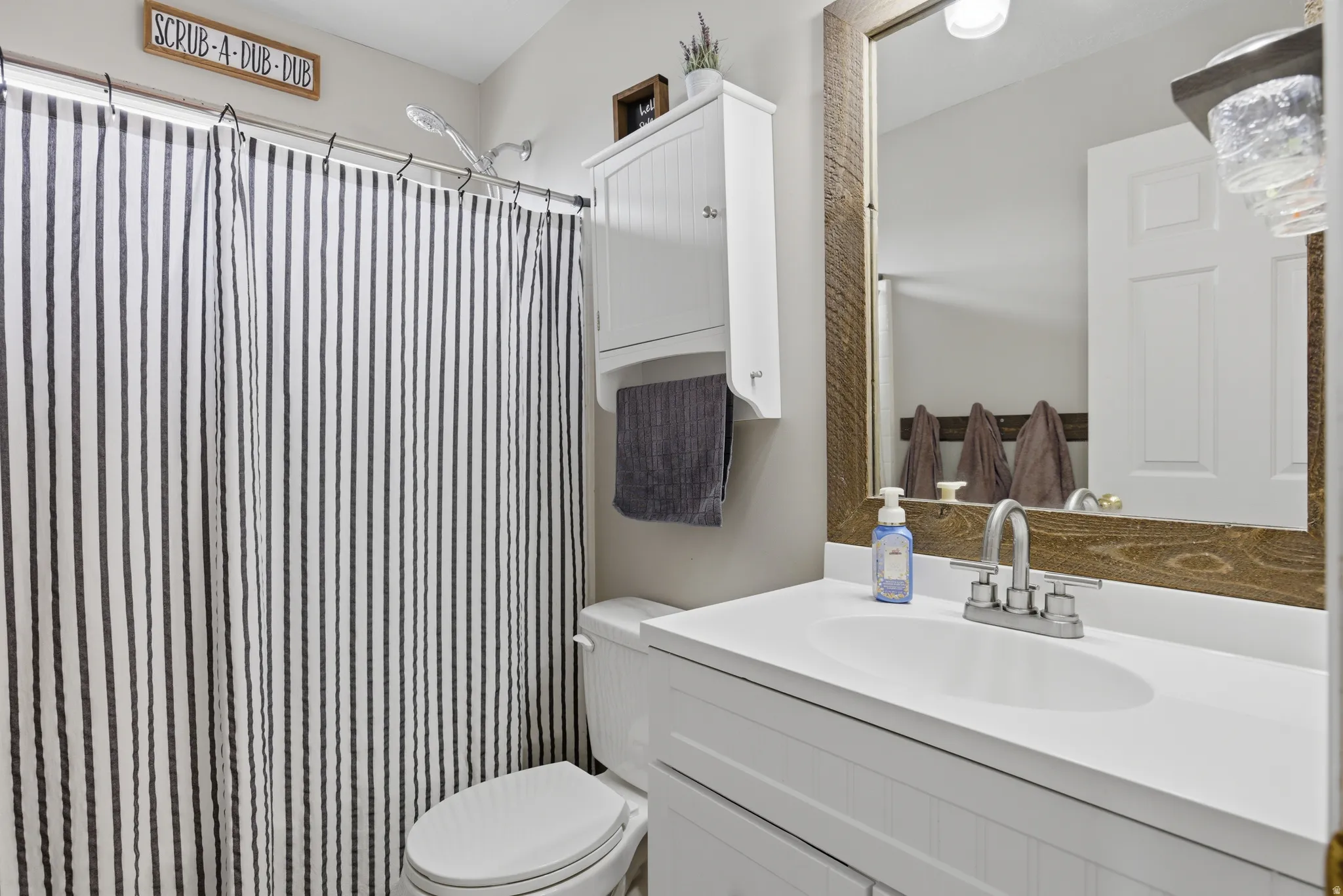 Bathroom featuring vanity and a shower with shower curtain
