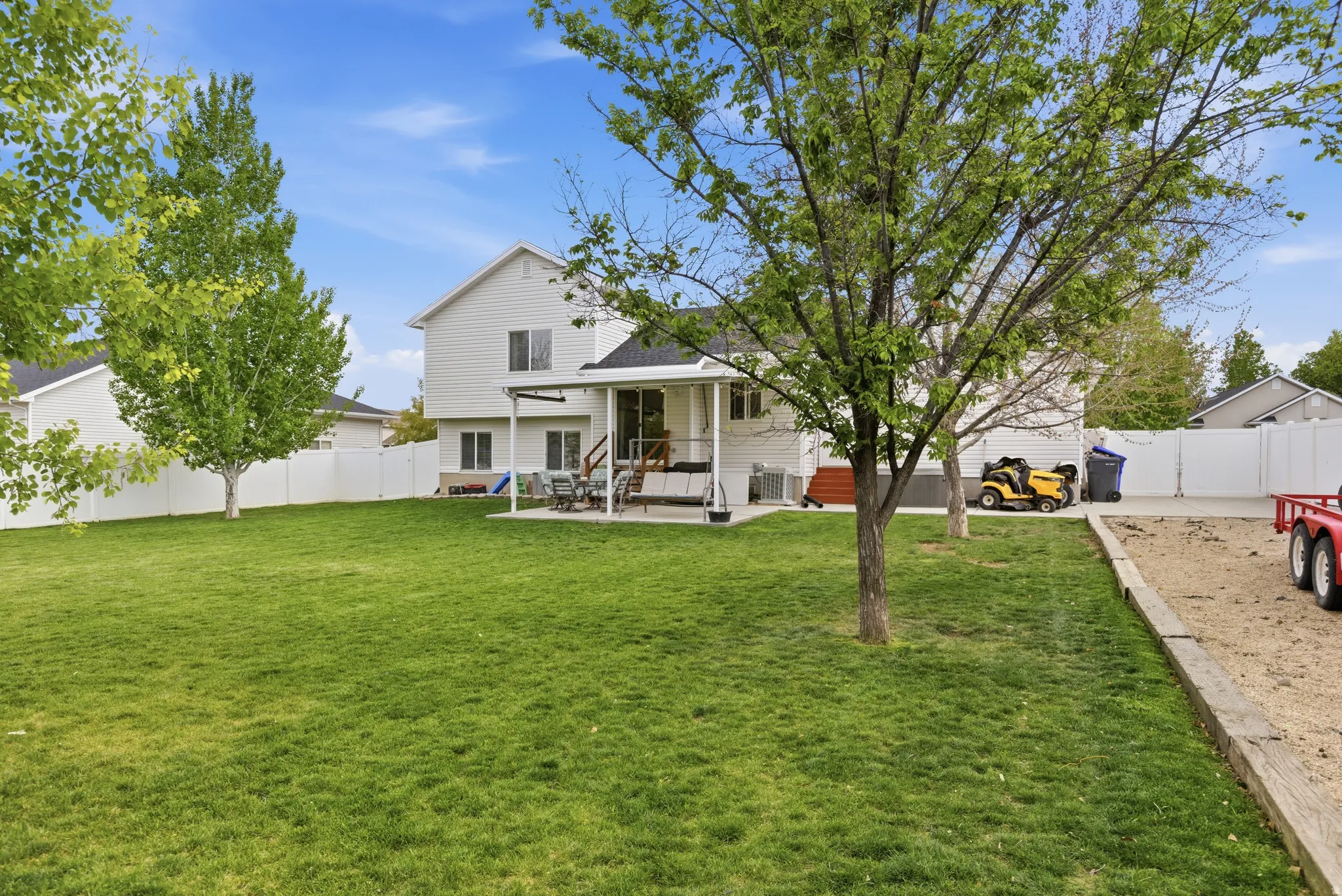 Rear view of property featuring a fenced backyard and a patio area