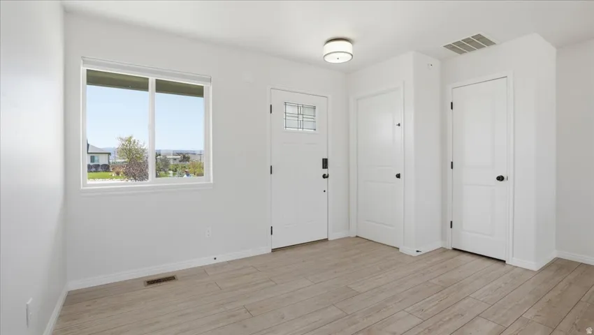 Foyer featuring light wood-type flooring and baseboards