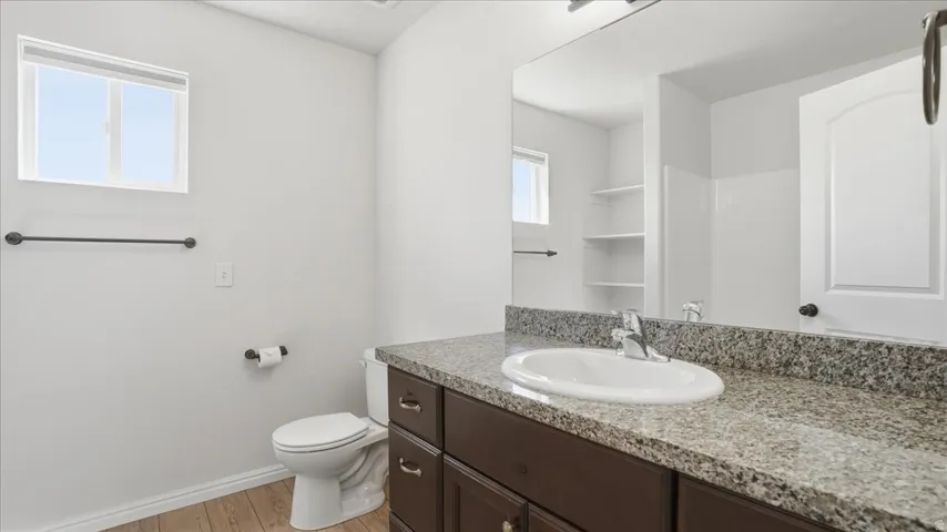 Bathroom with vanity and light wood finished floors