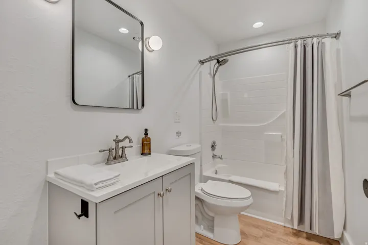 Full bathroom featuring vanity, shower / tub combo, light wood-type flooring, and recessed lighting