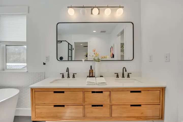 Full bathroom with a soaking tub, double vanity, and a stall shower