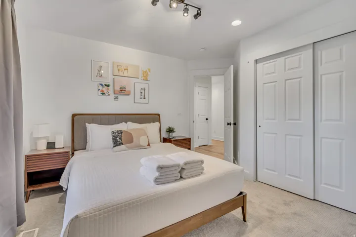 Bedroom featuring light carpet and a closet