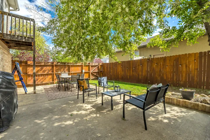 Fenced backyard featuring outdoor dining space, a patio, and area for grilling
