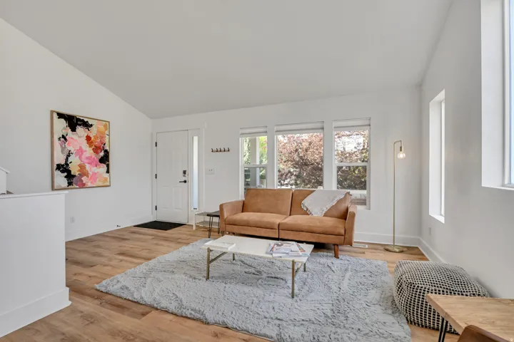 Living area featuring light wood-style flooring and vaulted ceiling