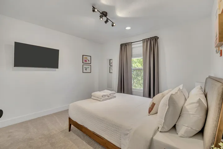Carpeted bedroom featuring baseboards