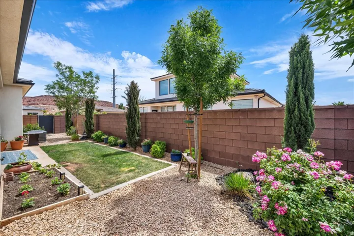 Fenced backyard featuring a garden