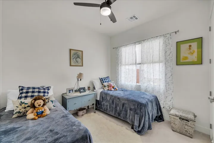 Bedroom featuring carpet and ceiling fan