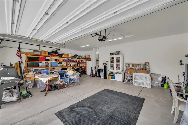 Garage featuring freestanding refrigerator