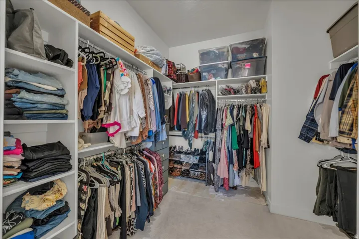 Walk in closet featuring light carpet