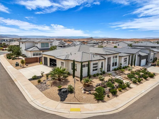 View of front facade with driveway, a residential view, and stone siding
