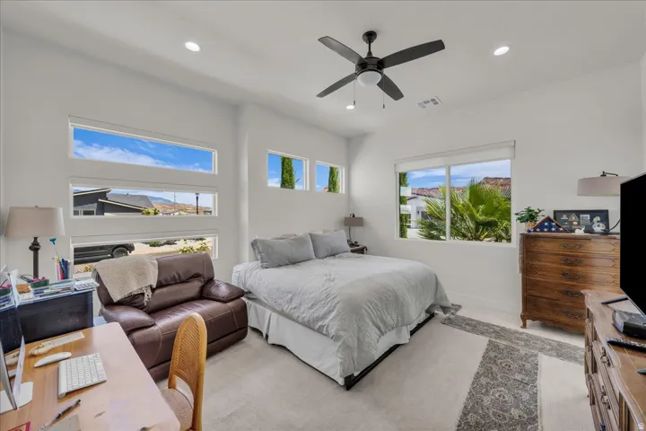 Bedroom with a ceiling fan, a desk, recessed lighting, and light carpet