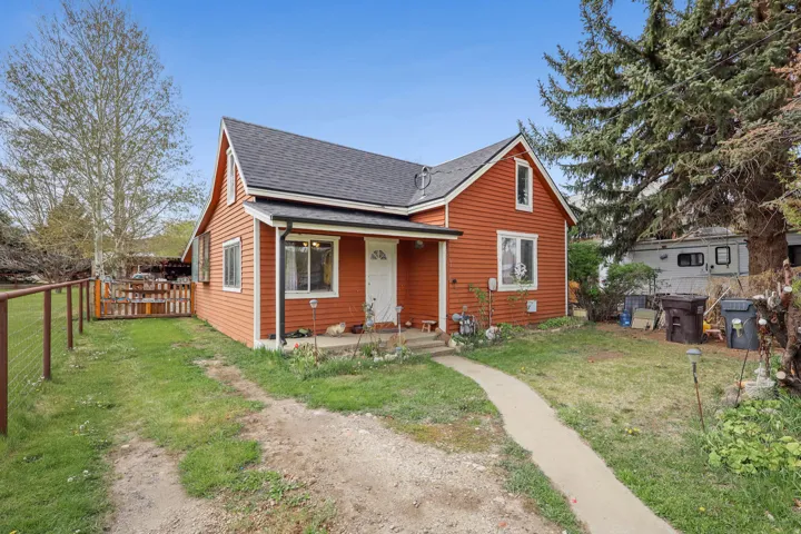 Bungalow with roof with shingles and a porch