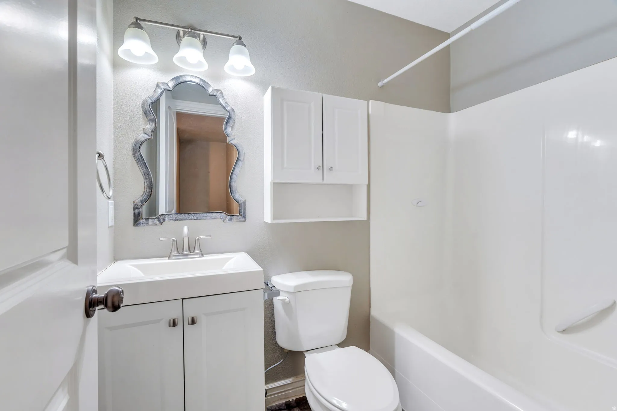 Bathroom with vanity and bathtub / shower combination