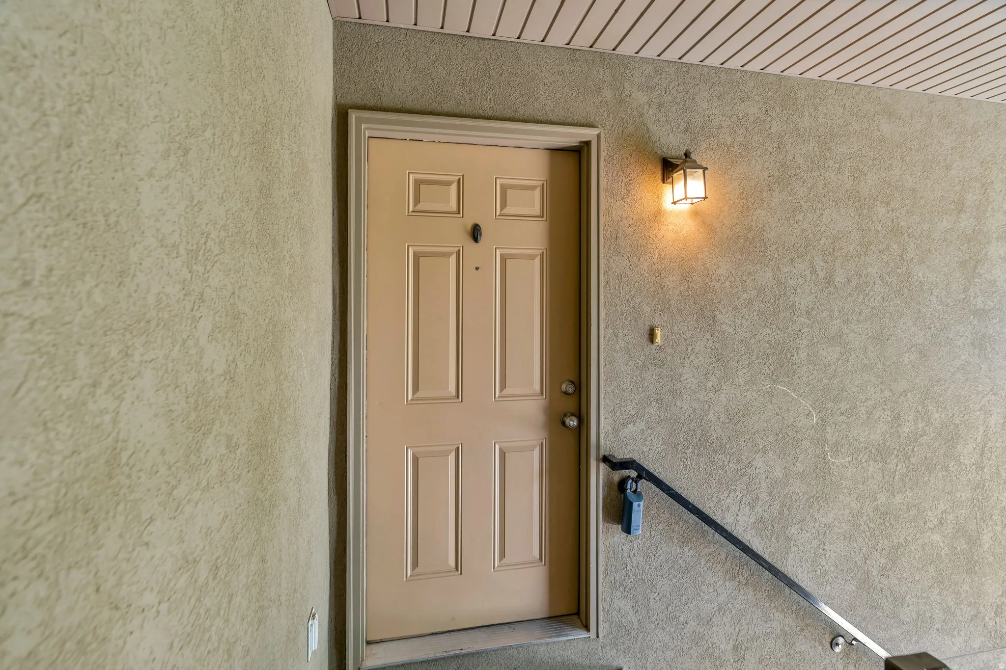Doorway to property with stucco siding