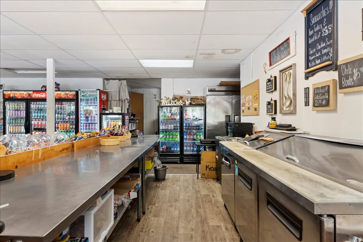 Kitchen with a paneled ceiling, modern cabinets, and stainless steel counters