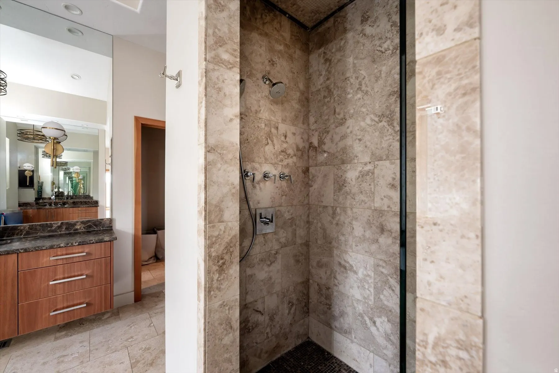 Bathroom with a tile shower and vanity