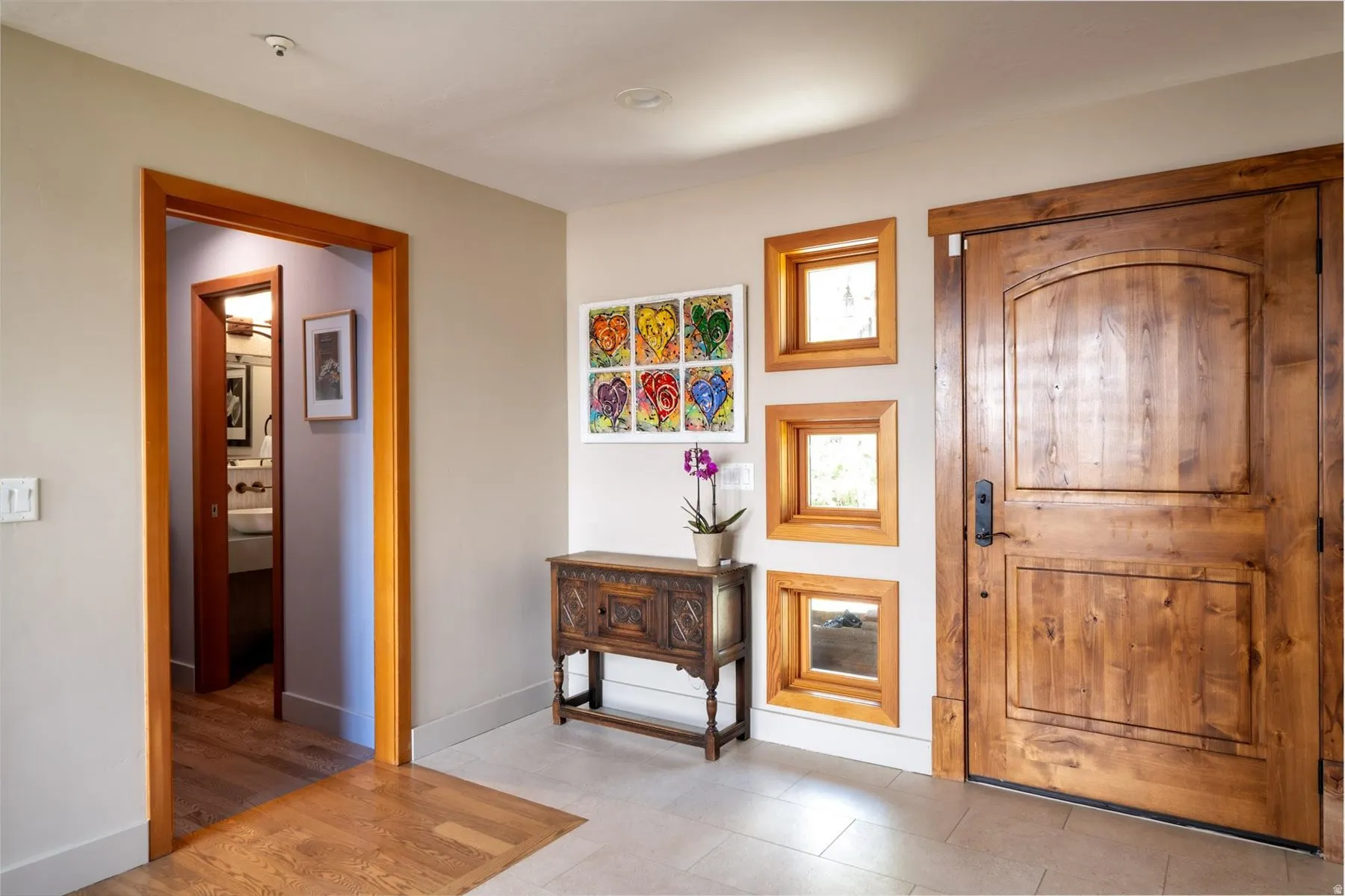 Entryway featuring baseboards and light tile patterned flooring