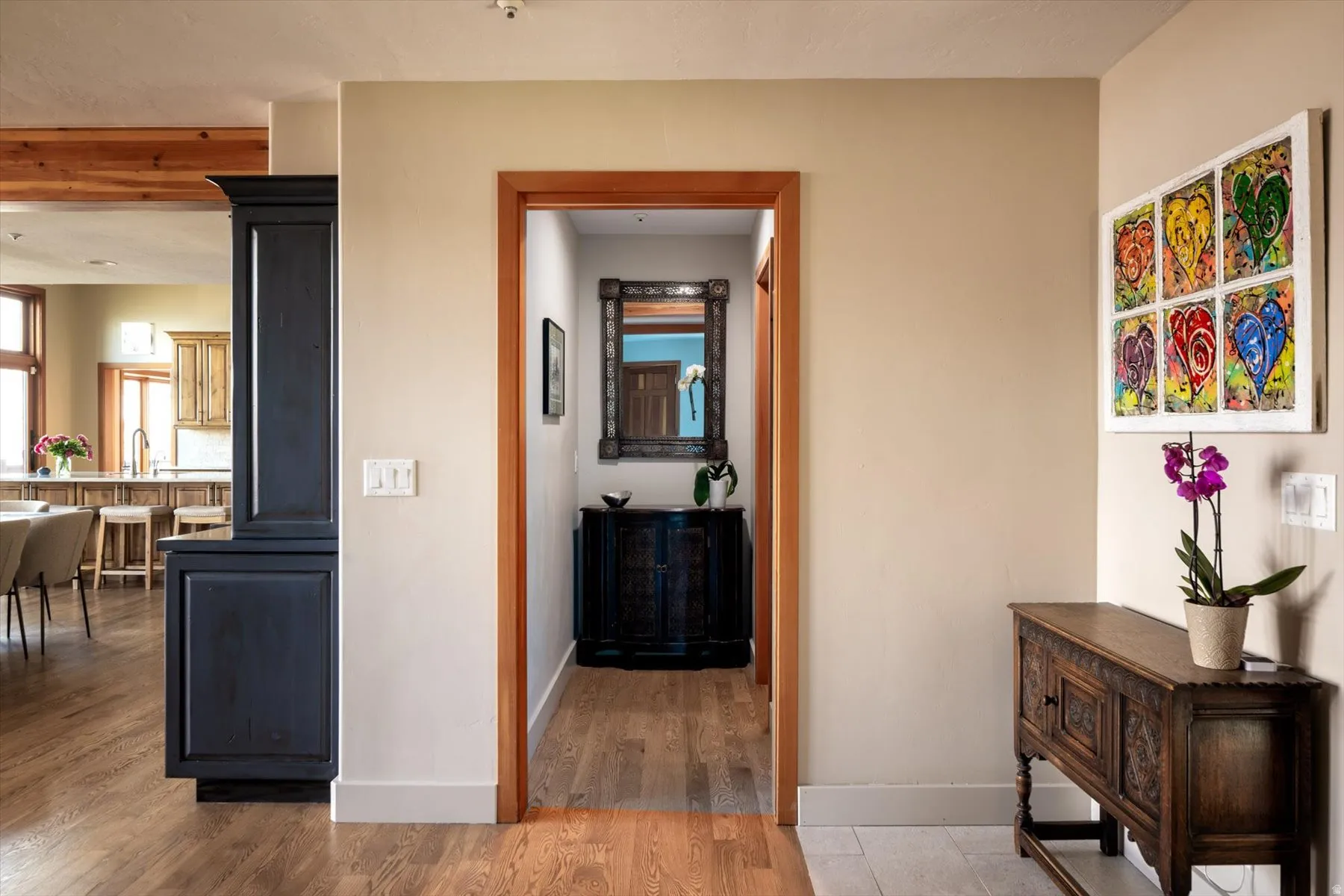 Corridor with light wood-type flooring and baseboards