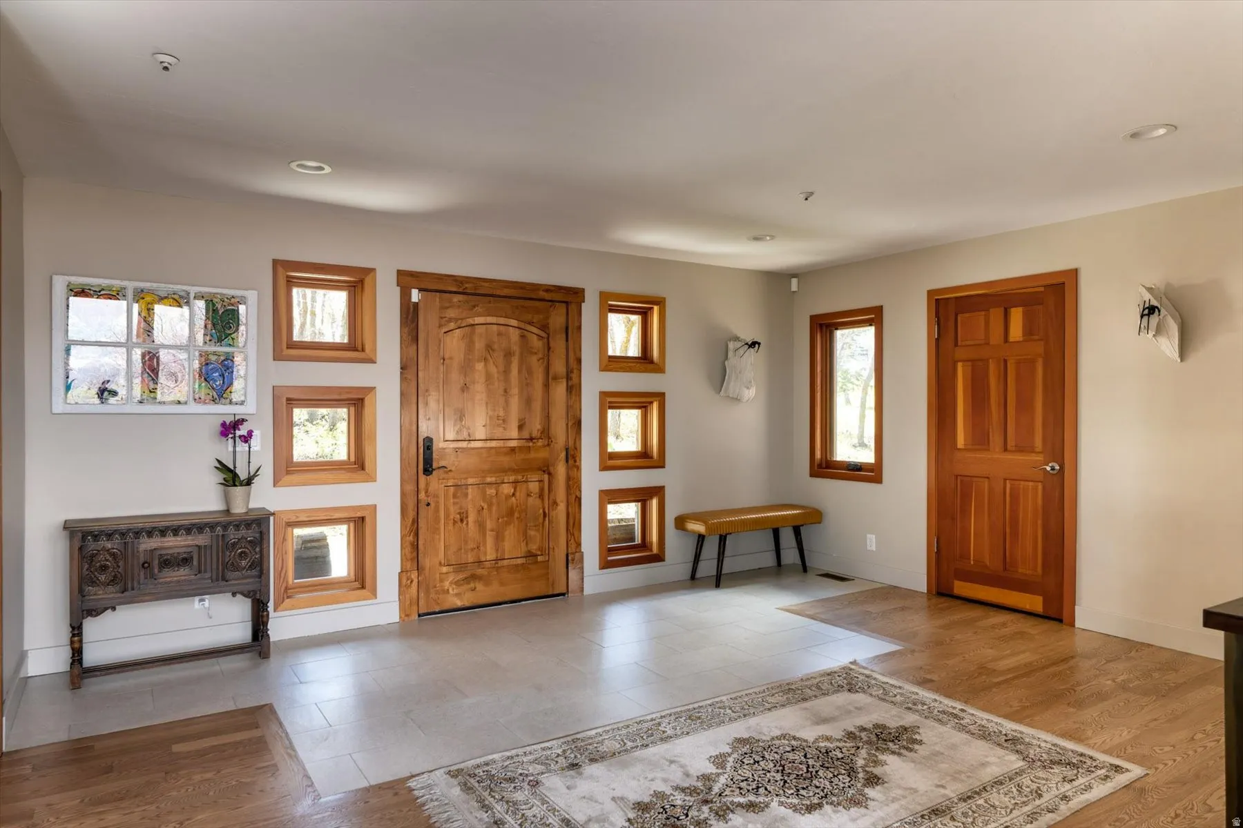 Foyer entrance with light wood-type flooring and baseboards