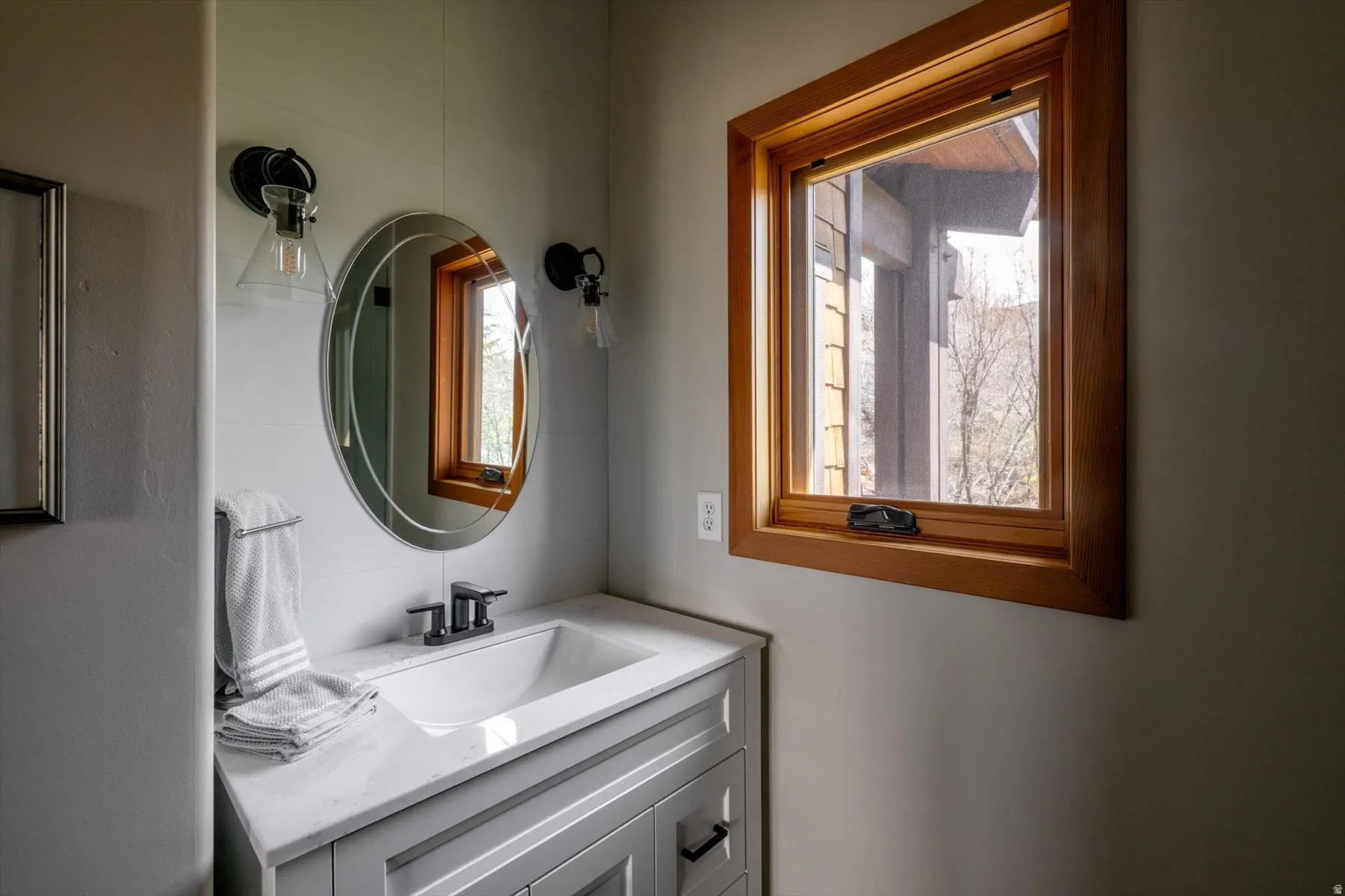Bathroom with vanity and healthy amount of natural light