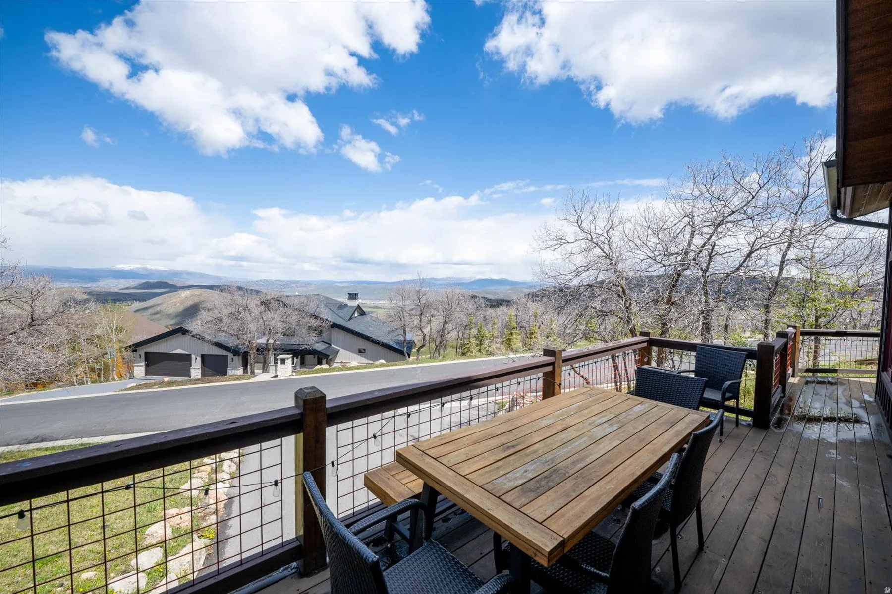 Wooden deck featuring outdoor dining space and a mountain view