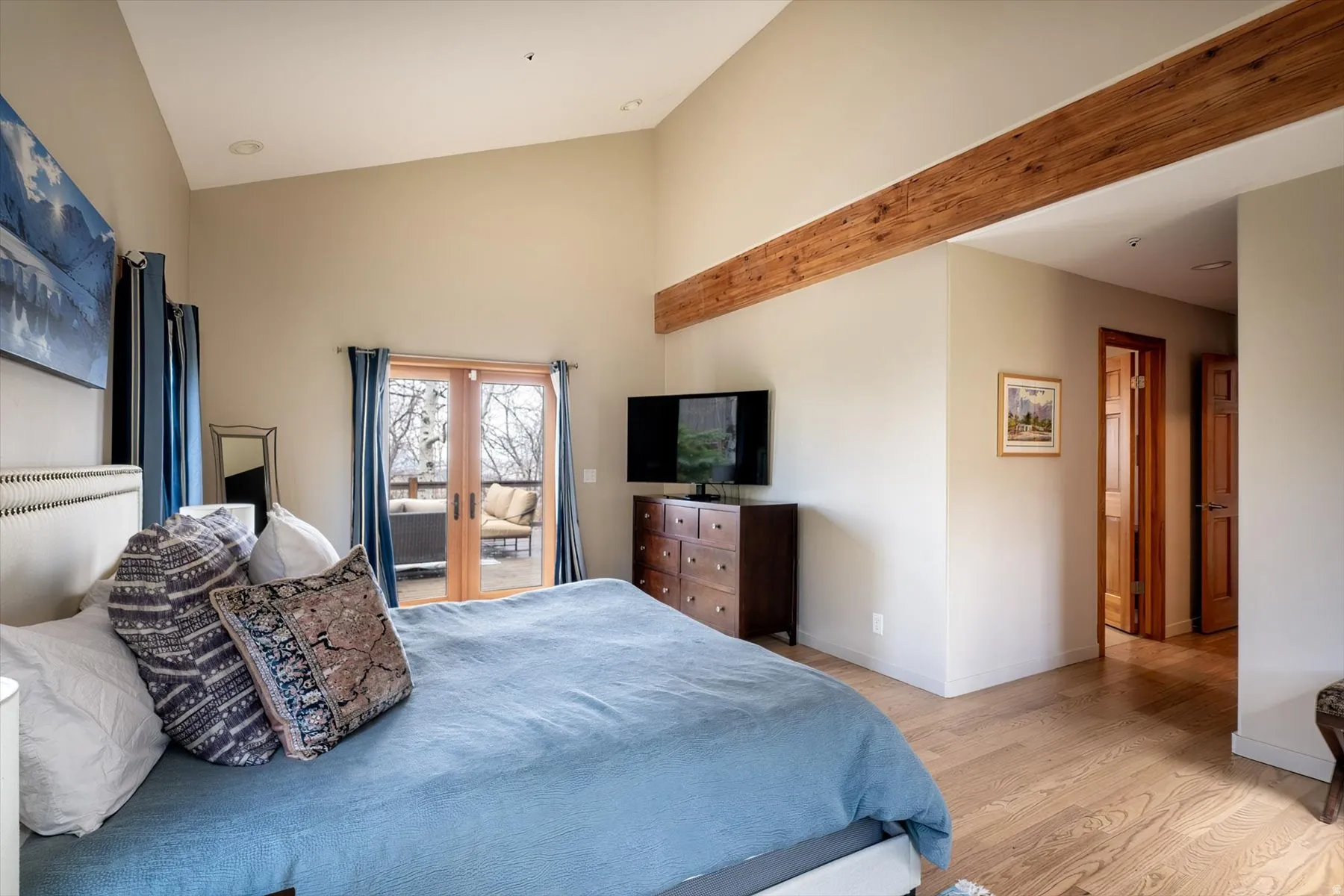 Bedroom featuring lofted ceiling, access to outside, and light wood finished floors