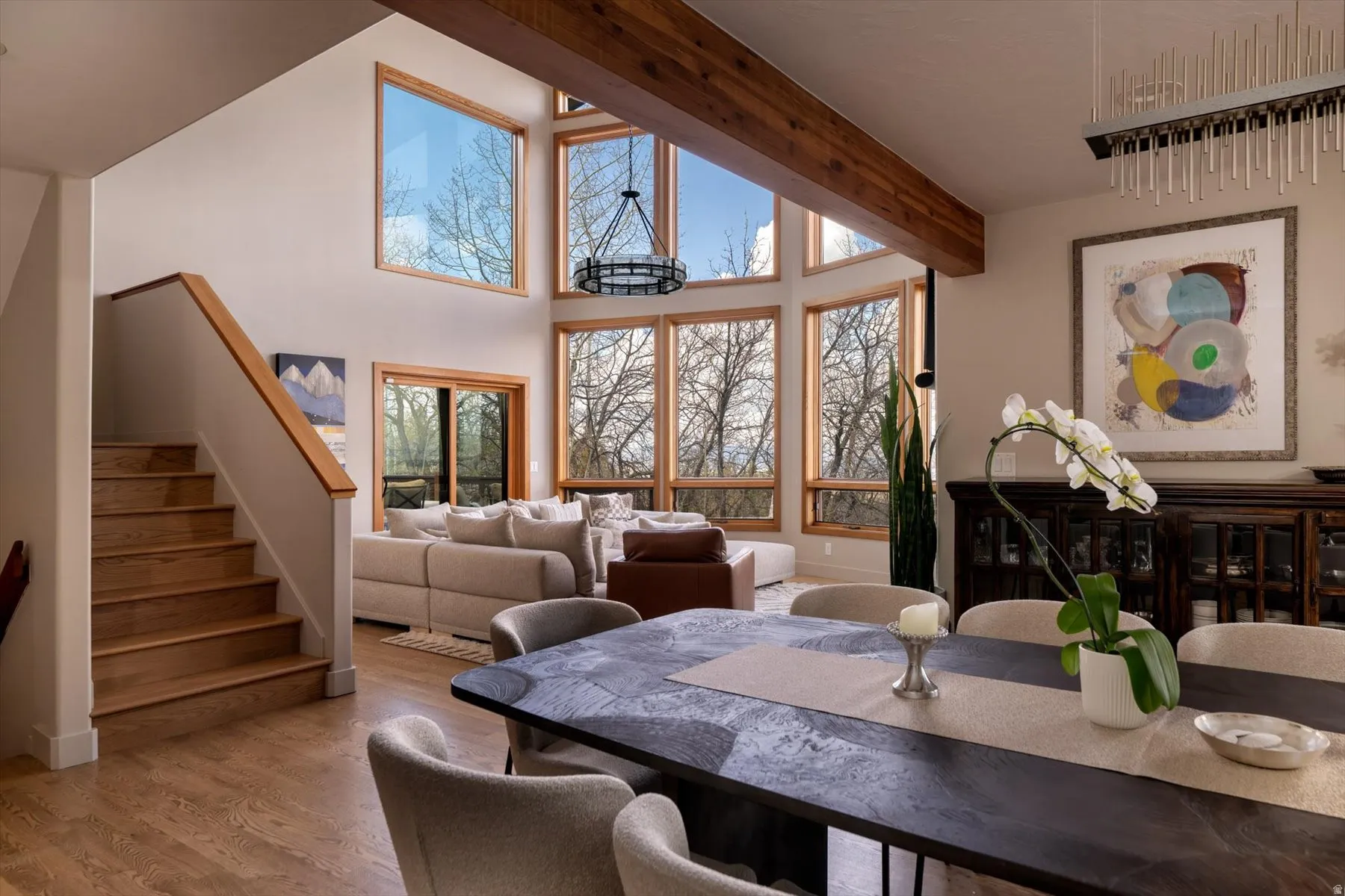 Dining space featuring wood finished floors, plenty of natural light, and lofted ceiling