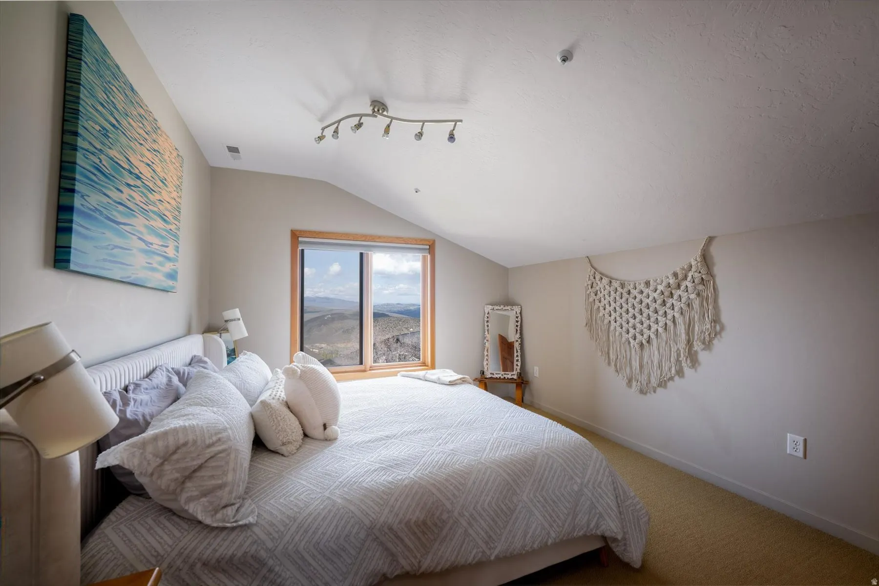 Bedroom with vaulted ceiling and carpet flooring