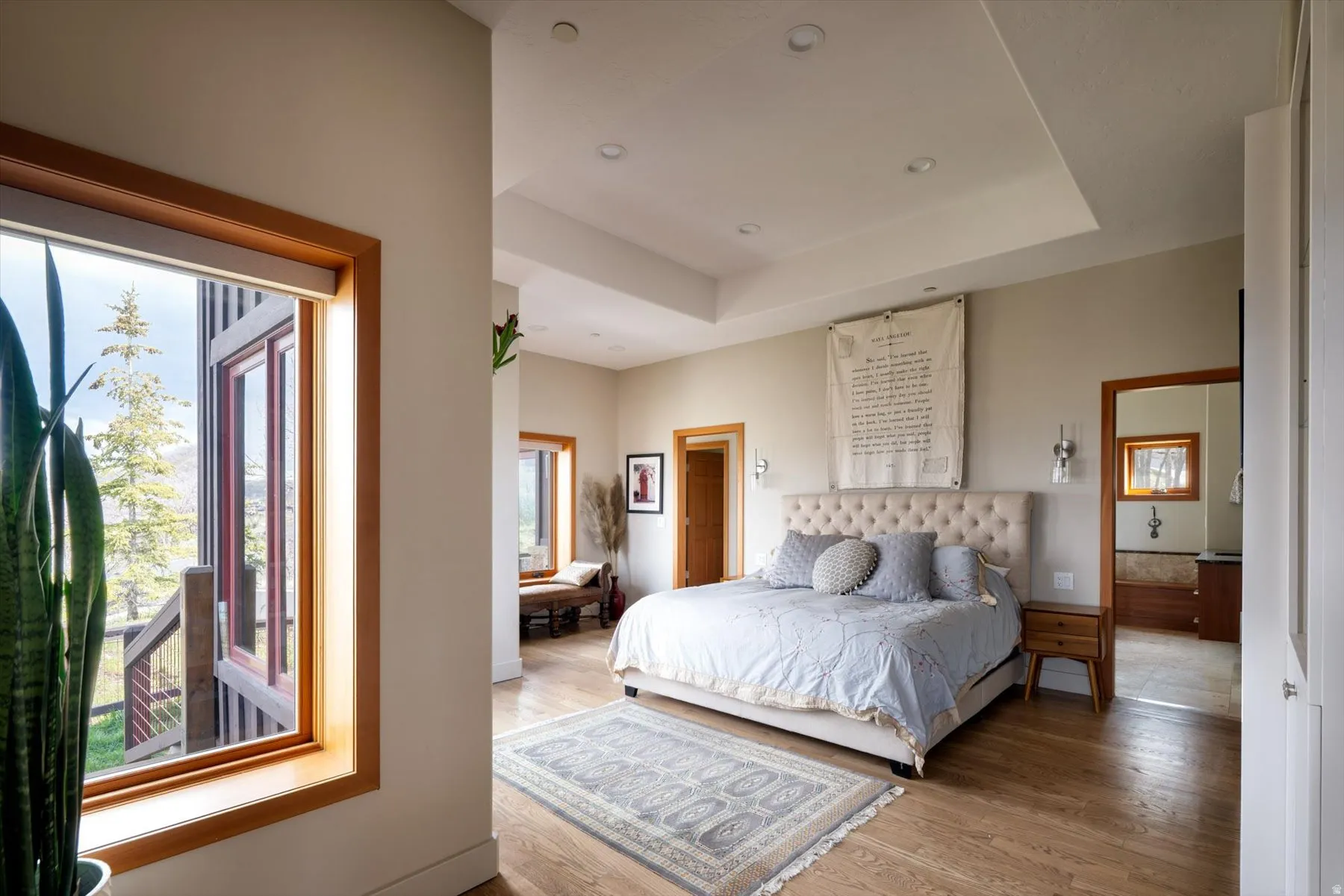 Bedroom featuring a tray ceiling, light wood finished floors, and recessed lighting