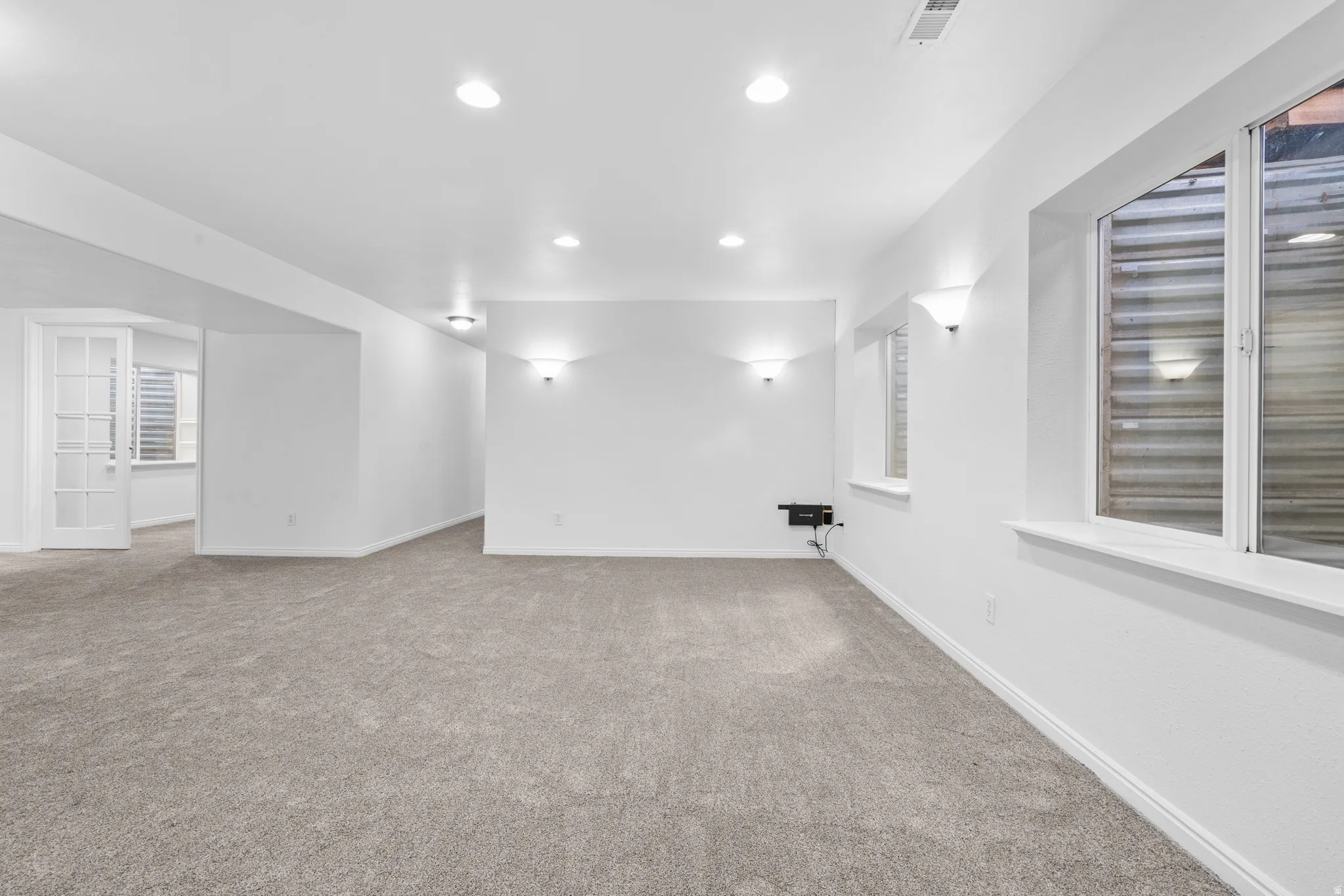 Unfurnished room featuring light carpet and recessed lighting