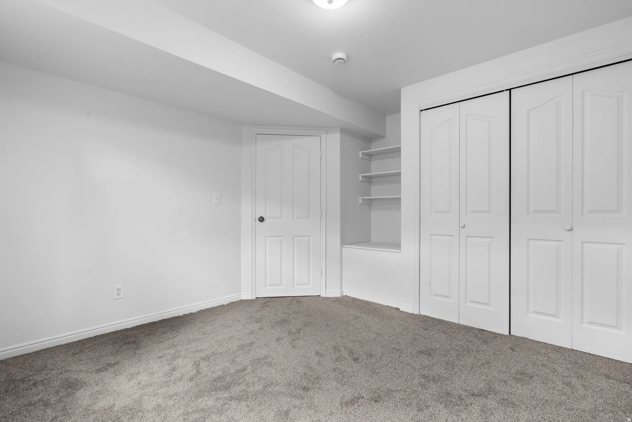 Unfurnished bedroom featuring a closet and carpet