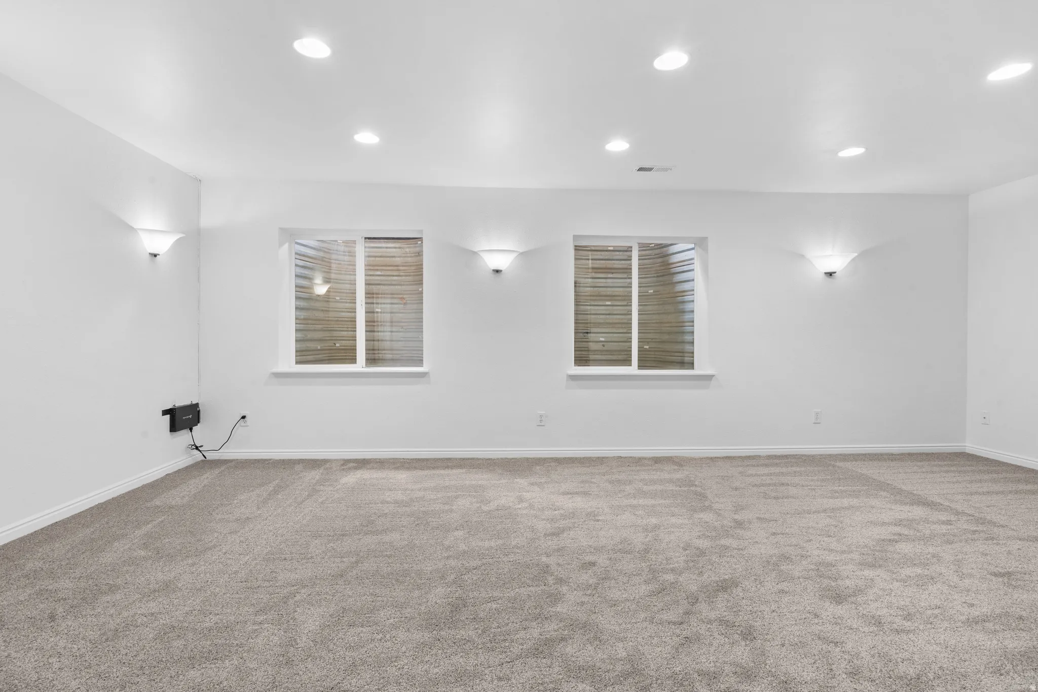 Empty room with carpet flooring and recessed lighting