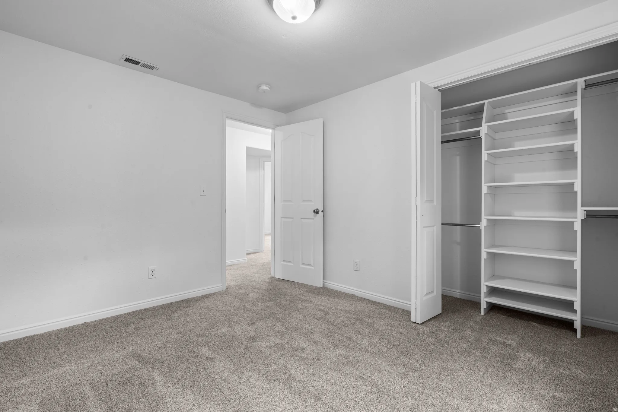 Unfurnished bedroom with carpet and a closet