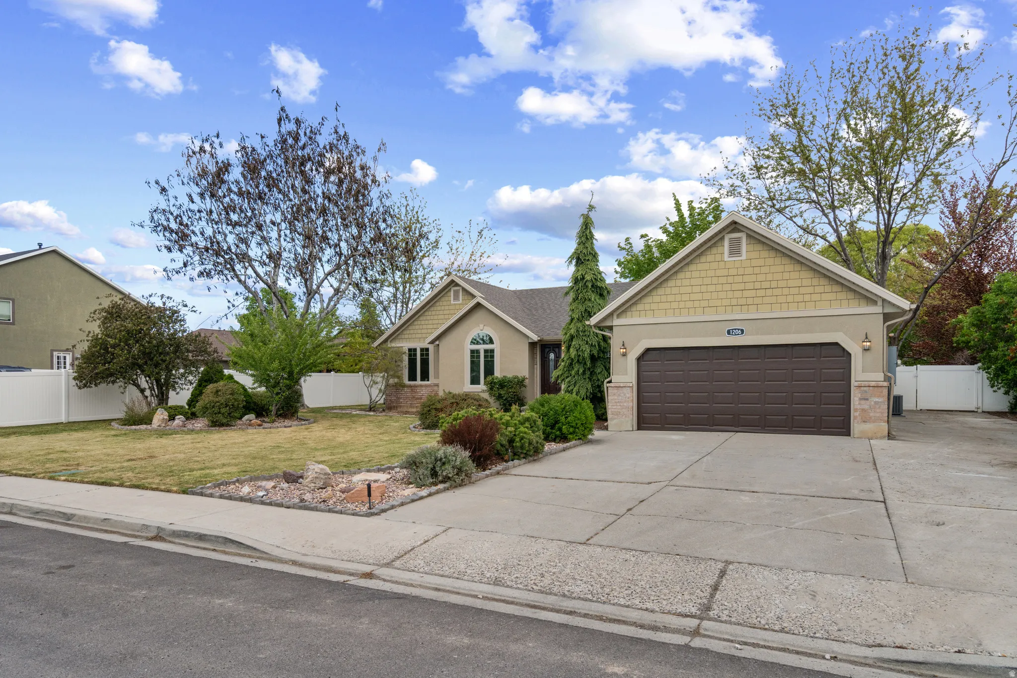 View of front of house with concrete driveway and an attached garage