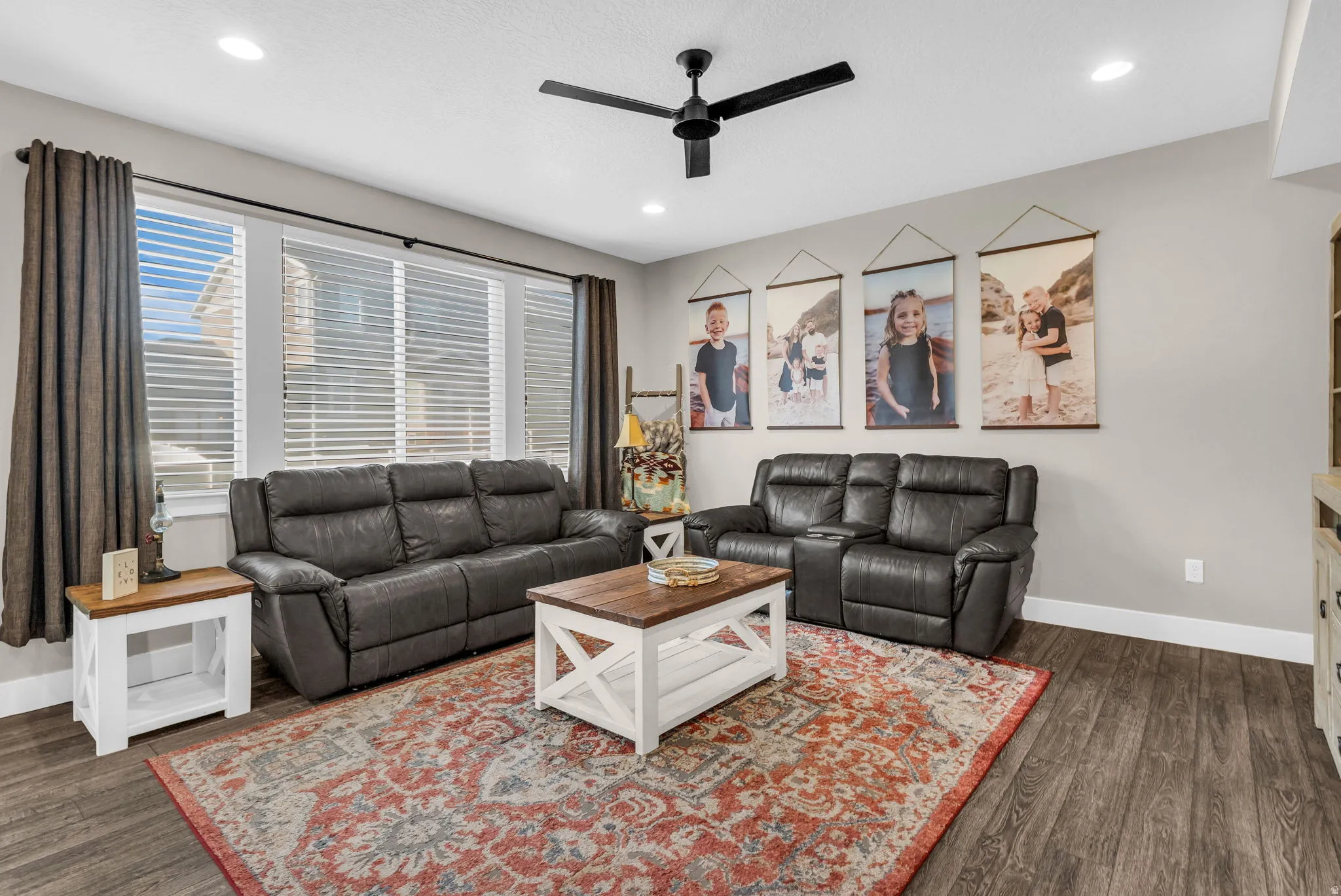 Living room with a ceiling fan, dark wood finished floors, and recessed lighting
