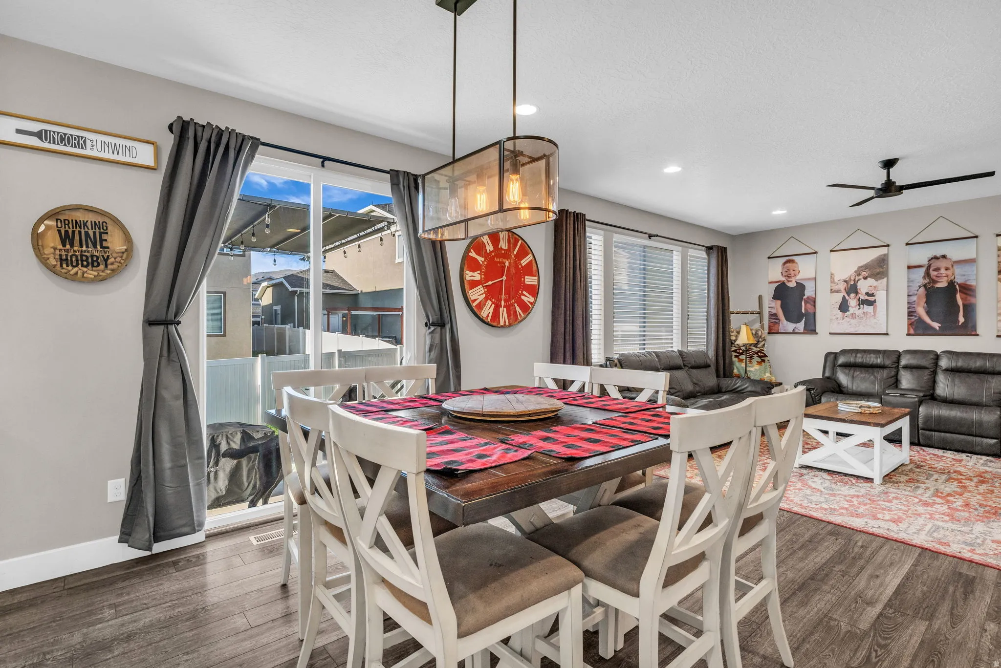 Dining area with dark wood-type flooring, ceiling fan, and recessed lighting