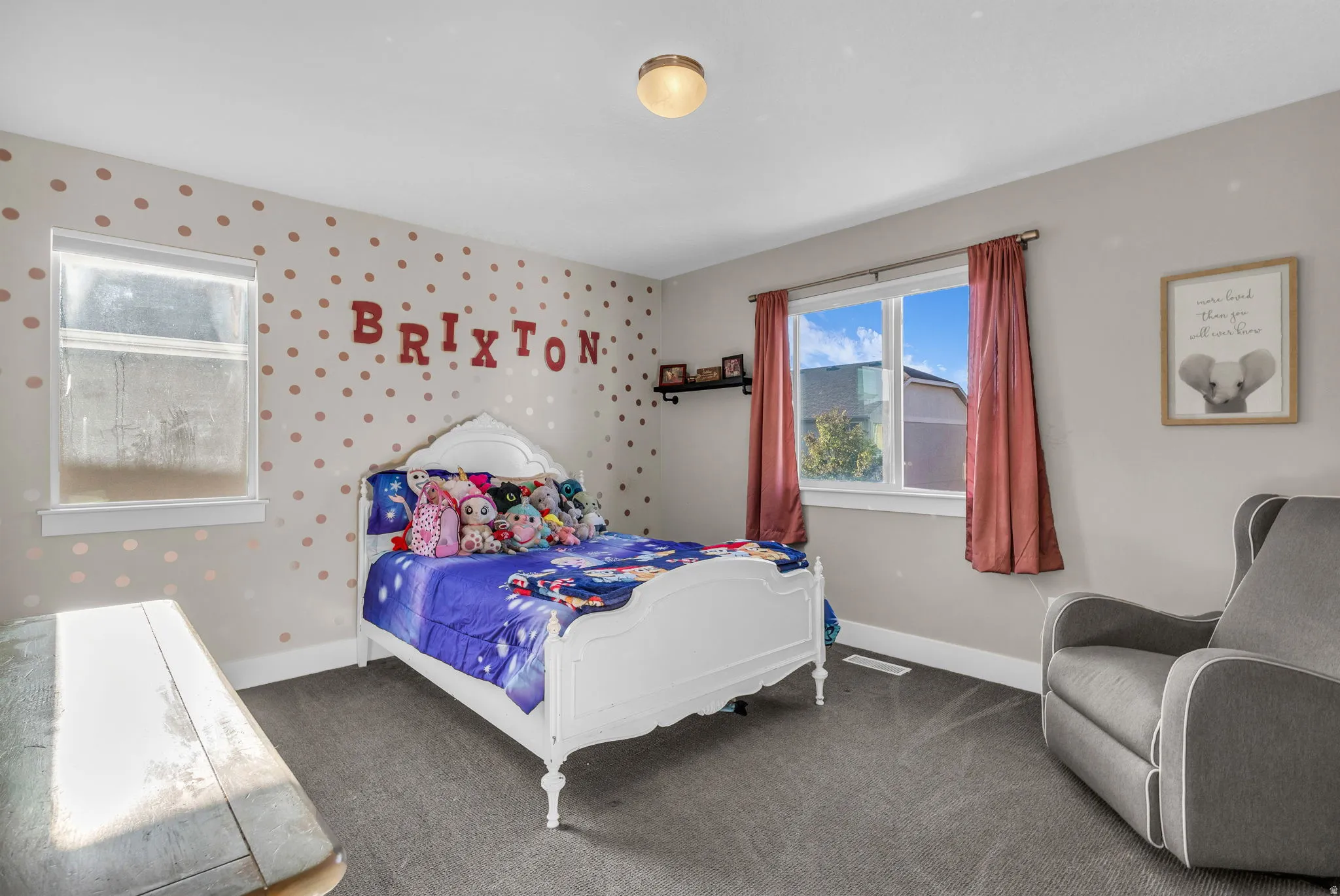 Carpeted bedroom with wallpapered walls