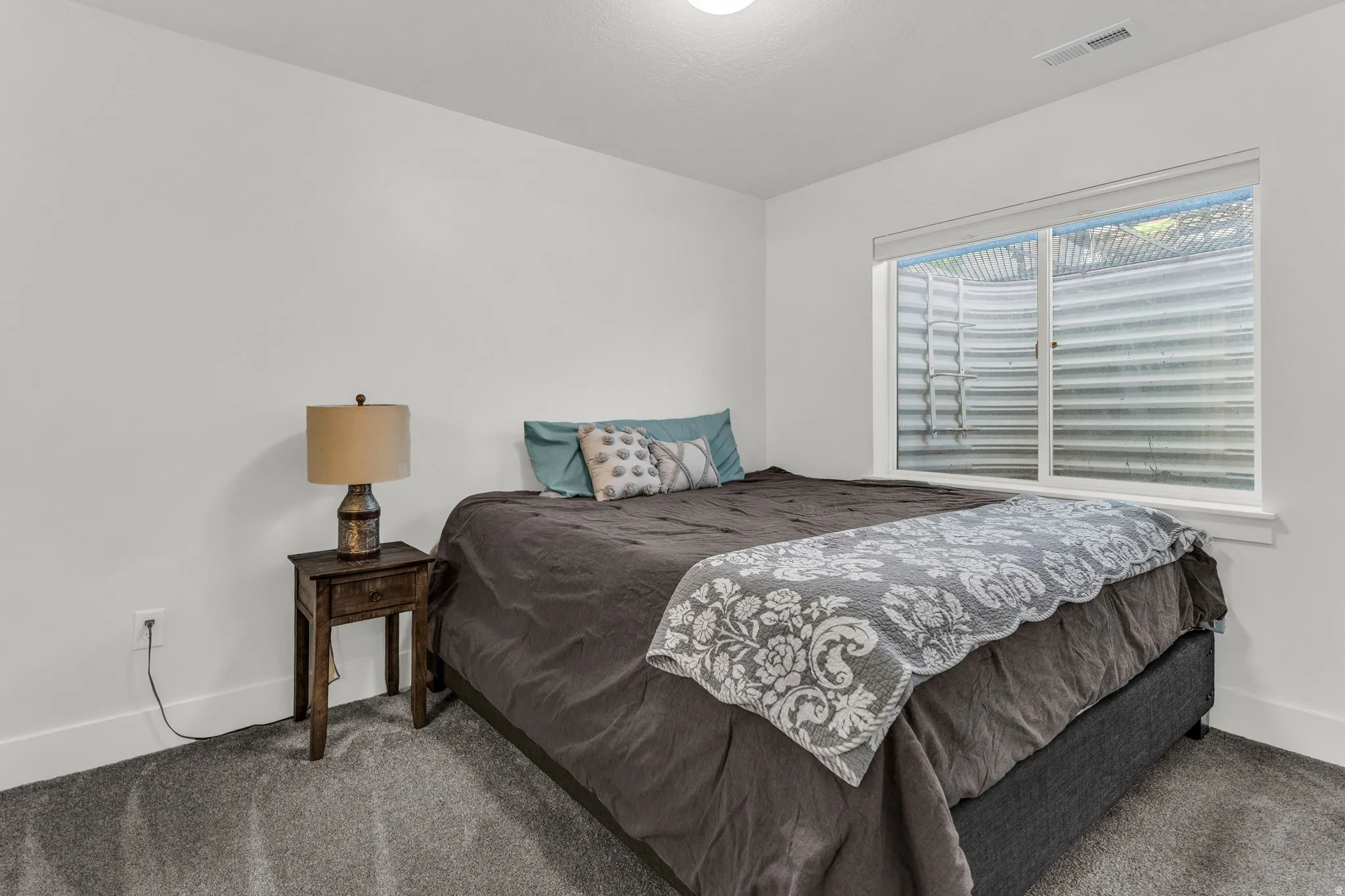Carpeted bedroom featuring baseboards