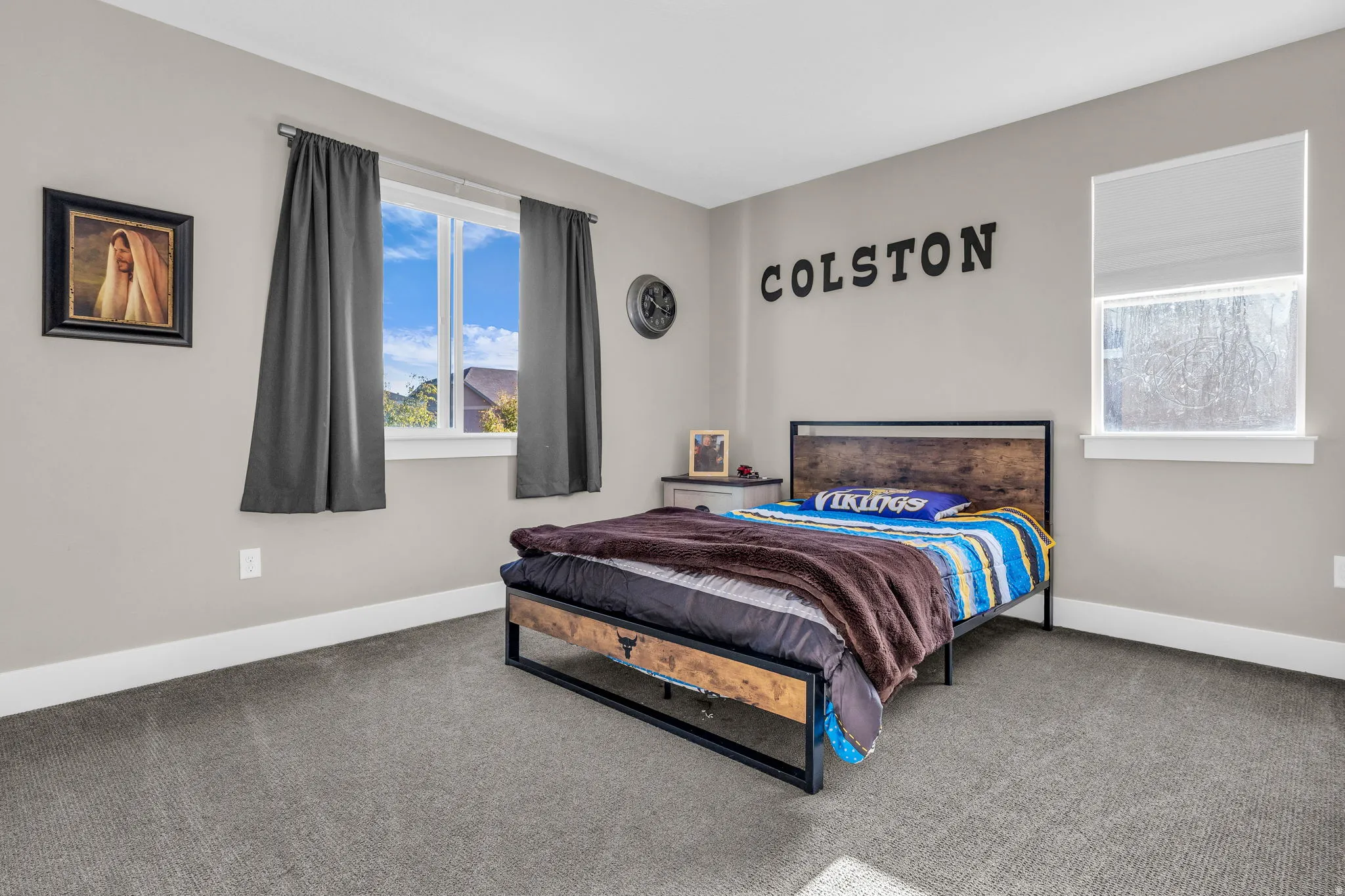 Bedroom featuring carpet floors and baseboards