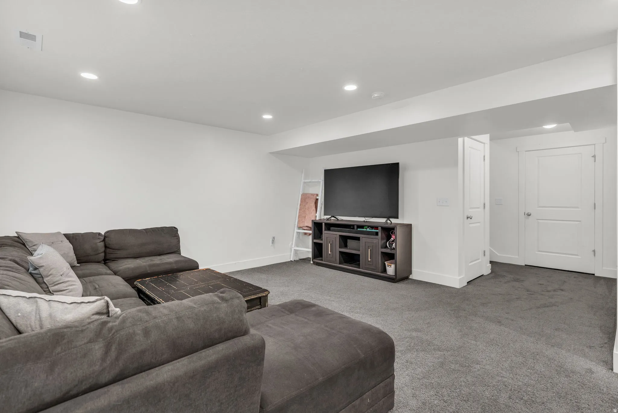 Living room featuring carpet flooring and recessed lighting