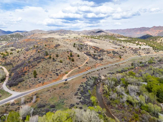 View of rural area featuring a mountain backdrop and a desert landscape